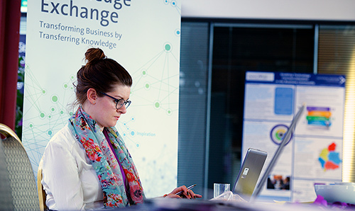 Bespectacled businesswoman concentrating on computer screen