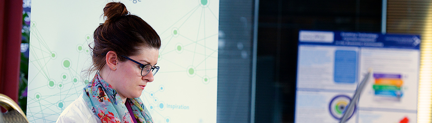 Bespectacled businesswoman concentrating on computer screen