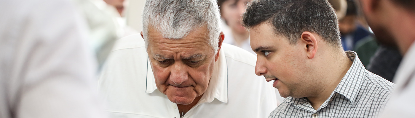 Two men talking at a trade show