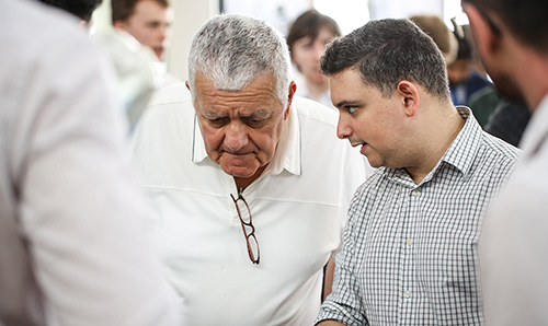 Two men talking at a trade show