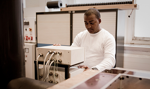 Researcher adjusting machinery in research centre