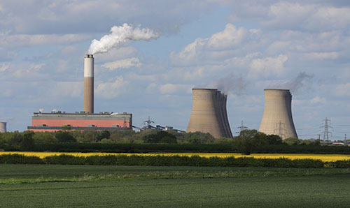 A power plant chimney emits steam