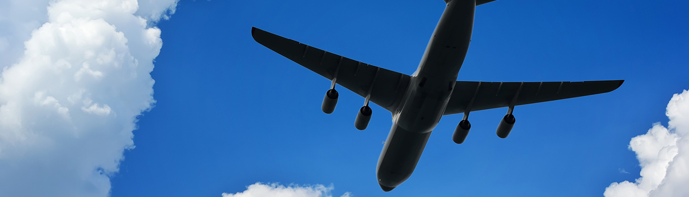 Airplane silhouette in deep blue sky