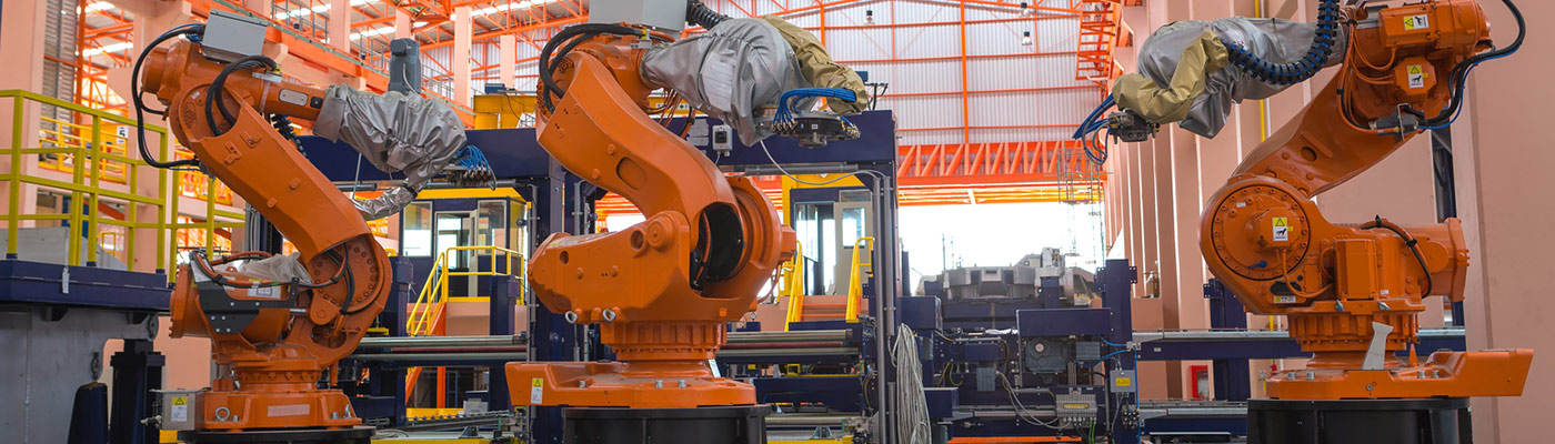 Robots welding in a production line