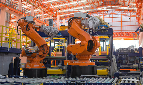 Robots welding in a production line