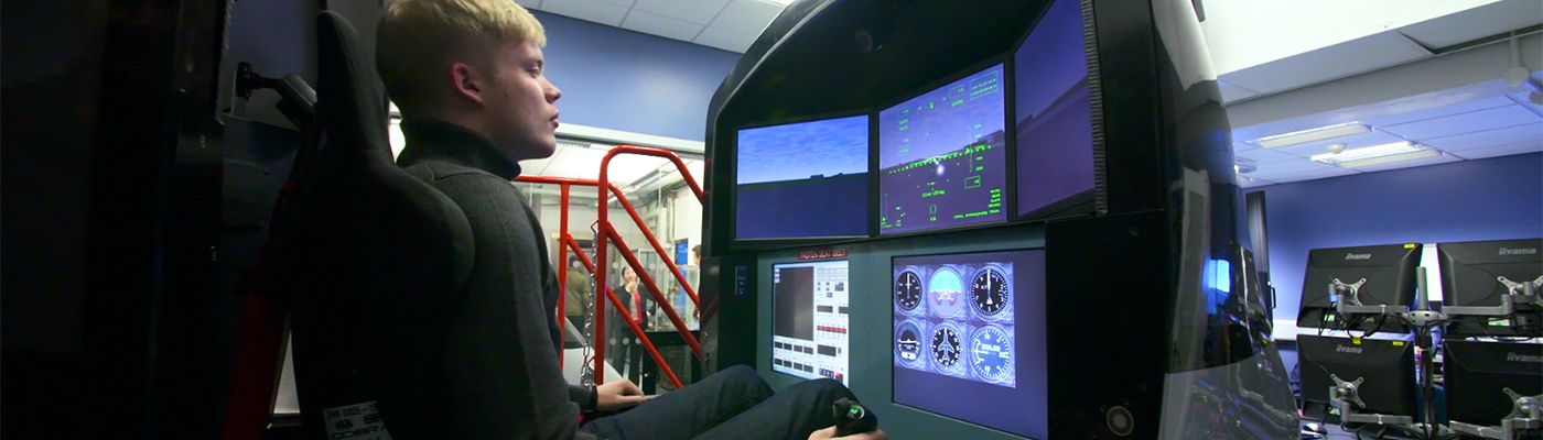 Undergraduate using flight simulator